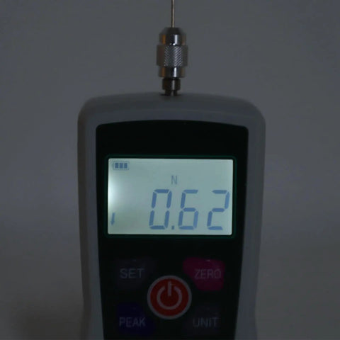 Close-up of Knockout Precision Digital Force Gauge Featuring Rock Solid Built In Sensor displaying 0.62N reading for precise measurements.