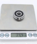 Built Tough V Groove Sealed Ball Bearings Precision Crafted 10 X 32 X 9 mm Heavy Duty Pulley Wheel Roller on scale weighing 34.47 grams.