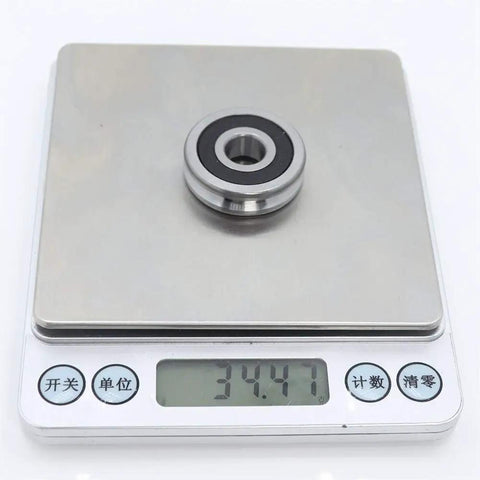 Built Tough V Groove Sealed Ball Bearings Precision Crafted 10 X 32 X 9 mm Heavy Duty Pulley Wheel Roller on scale weighing 34.47 grams.