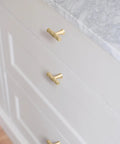 High Quality Hammered Brushed Gold Cabinet Knobs 20 Pack Solid Zinc Alloy Drawer Handles on white cabinet with marble surface.