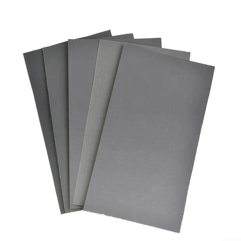Dope Wet And Dry Sandpaper Kit Silicon Carbide 15 Pack 400 To 3000 Grit sheets fanned out on a white background