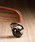 Get Your Furniture Rolling Smooth With 2 Inch Rubber Ball Casters Heavy Duty 80 Lb Rating Bright Brass Hood And 5 16 X 1 1 2 Friction Stem Swivel For Couches And Chairs 2 Pack close-up of black rubber ball caster with brass hood.
