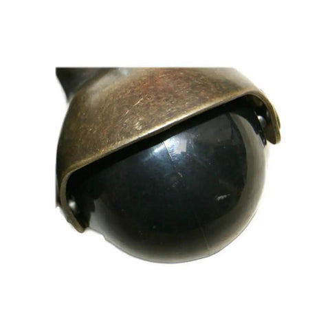 Rock Solid Set Of 4 Two Inch Ball Casters Featuring M8 Screw Threads and True 360 Swivel Spin Finished In Vintage Antique Brass close-up view of black ball.