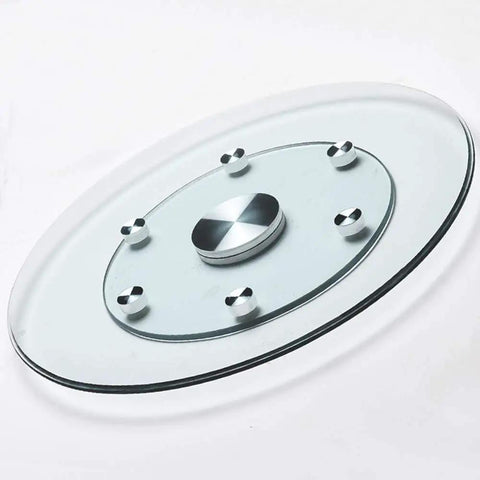 Heavy Duty Tempered Glass Lazy Susan Turntable With Large Rotating Serving Tray and 360 Degree Smooth Spin Anti Collision Edge Built Solid for a Total Game Changer Kitchen Table Setup, top view with polished metal base.