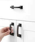 Hand reaching for 10 Pack 3 Inch Oil Rubbed Bronze Drawer Pulls Brushed Bronze Cabinet Handles for Cabinets and Drawers Ideal for Kitchen Bedroom Dresser