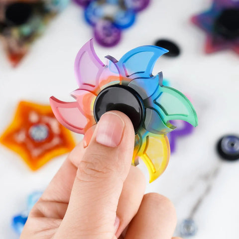 Top Shelf Chrome Steel Fidget Spinner Bearings And Caps MR137 Precision High Speed 16 Pack in colorful spinner design held by a finger.