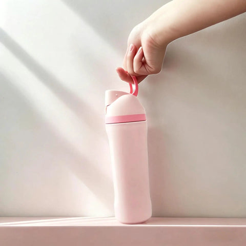 Hand holding pink Insulated Stainless Steel Water Bottle With Built-In Straw, Leak-Proof Seal, BPA-Free, Perfect For Sports And Travel