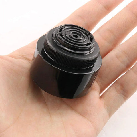 Tough As Nails 24V DC Piezo Buzzer Alarm Sounder Emitting Persistent Continuous Beep Signal Screw Terminal Mount shown in hand.