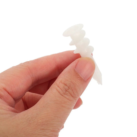 Hand holding a single anchor from the 300 Pack White Drywall Anchors Kit DIY Ready Self Drilling Heavy Duty Wall Hangers