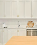 Modern kitchen scene featuring Pro Grade Brushed Gold Cabinet Handles And Sleek Modern Pulls With A Straightforward Three Inch Hole Center Spacing Heavy Duty Zinc Frame For No Fuss Installation And Sharp Home Refresh Smooth Glide Two Pack.