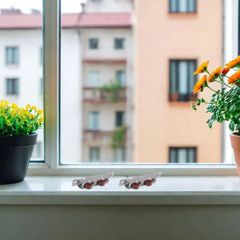 Stainless Steel Sliding Window Roller Double Wheel Heavy Duty Track Replacement 4 Pack on windowsill with potted plants.