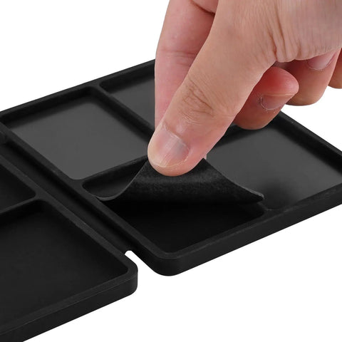 Hand lifting magnetic sheet on Portable Tri Fold Silicone Tool Tray With Magnetic Sheets Included Heat Resistant And Flame Retardant