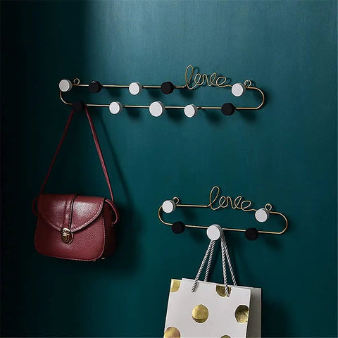 Top Tier Wrought Iron Letter Wall Hooks Slick Gold Finish Heavy Duty Coat And Key Hangers Modern Entryway Decor. Stylish hooks holding bags.