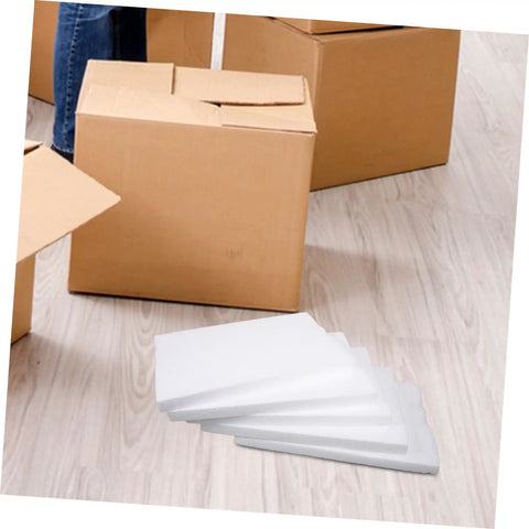 Top Shelf White Foam Board Packing Inserts For Shipping Cushion Protection Reusable Packaging Liners stacked beside cardboard boxes.