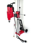 Tough As Nails 25 Inch Concrete Core Drill With 5000W Two Speed Diamond Coring Rig, featuring a red drill on a tilting stand.