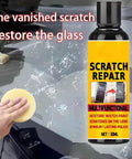 Close-up of a hand using a 30ml scratch repair fluid on a vehicle windshield to restore glass and remove scratches.