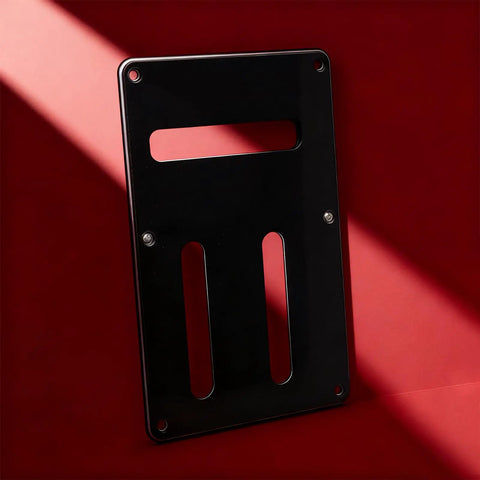 Guitar Back Panel Replacement Part For Electric Guitars, Lightweight precision fit, black sleek finish backplate on red background