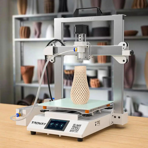 Kickstart Your Maker Flow With This Folding Ceramic 3D Printer Engineered For Clay And Slurry Ready To Roll Right Out Of The Box, showcasing a clay vase being printed.
