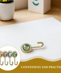 Slick Four Pack Adhesive Wall Hooks For Hanging Towels And Robes With Knockout Grip No Drilling Required Super Quick Mount For Bathroom Kitchen Or Entryway Storage, showing a green decorative hook.