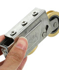 Heavy Duty Door Pulley And Sliding Roller Featuring Dual Copper Wheels Plus Precision Ball Bearings For Quiet Window And Patio Door Replacement Hardware That Works Like A Charm held in hand.