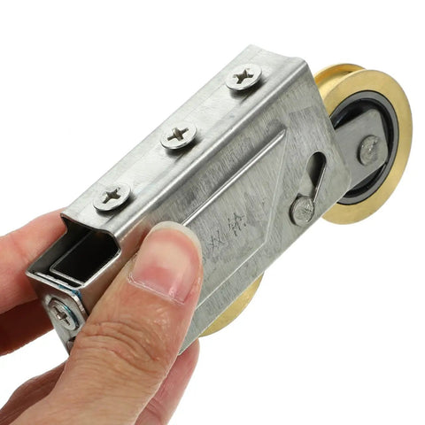 Heavy Duty Door Pulley And Sliding Roller Featuring Dual Copper Wheels Plus Precision Ball Bearings For Quiet Window And Patio Door Replacement Hardware That Works Like A Charm held in hand.