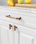Ten Pack Champagne Bronze Cabinet Knobs For Modern Kitchen Cupboards And Vanities Featuring Sleek Brushed Brass Gold Hardware displayed on white cabinets.
