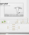 White cabinet with Solid Brass Cabinet Pulls 4 Pack 3 3/4 Inch Brushed Gold Modern Drawer Handles For Kitchen Cabinets Dressers Wardrobes 96mm Hole Centers Heavy Duty Durable Solid Construction, under a framed flower artwork