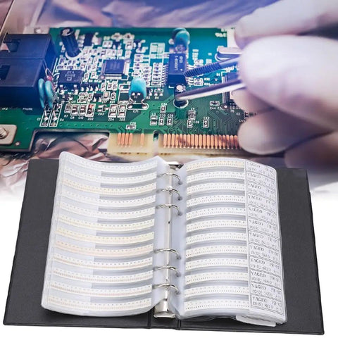 Top Tier 0402 Resistor Assortment Kit With 8500 Pieces And 170 Values in a labeled book beside a circuit board.