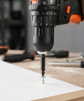 Power drill using Six Piece Damaged Screw Extractor Set For Easy Out Bolts, Stripped Screw Remover Tool, And Stud Removal on wood panel