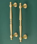 Heavy Duty Five Inch Solid Brass Cabinet Pulls In Brushed Matte Gold for kitchen cabinetry and bathroom vanities on green background.
