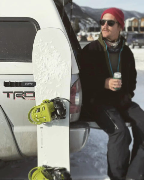 Badass Magnetic Ski And Snowboard Vehicle Rack Keeping Your Ride Spotless With Soft Waterproof Padding For Reliable All Season Winter Storage And Trail Ready Adventures mounted on truck with snowboard.