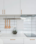Modern kitchen with 10 Pack 5 Inch Champagne Bronze Cabinet Handles For Kitchen Cabinets And Furniture Pulls installed on white cabinets.