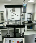 Heavy Duty Digital Force Gauge Featuring Bulletproof S Type Sensor And Quick Tap Peak Hold Mode For Straight Ahead Push Pull Testing Up To 1000 Newtons On Any Job Site Bench in lab setting.