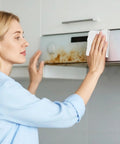 Woman using Heavy Duty Kitchen Cleaning Wipes For Microwave Air Fryer Stove And Cooktops All Purpose Appliance Cleaner Cloths