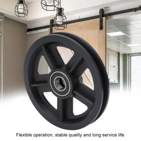 Heavy Duty Bad Boy Barn Door Hanging Rollers Featuring Dead Silent Bearings Premium Nylon Sliding Door Pulley Wheels close-up view of a black nylon wheel