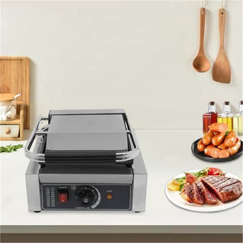Heavy Duty 1800W Commercial Sandwich Panini Press Grill on countertop with cooked food and adjustable temperature control knob.