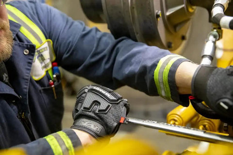 Person using tools wearing Winter Ready Insulated Work Gloves With Impact Protection, X Large, Black And Grey, in a work setting