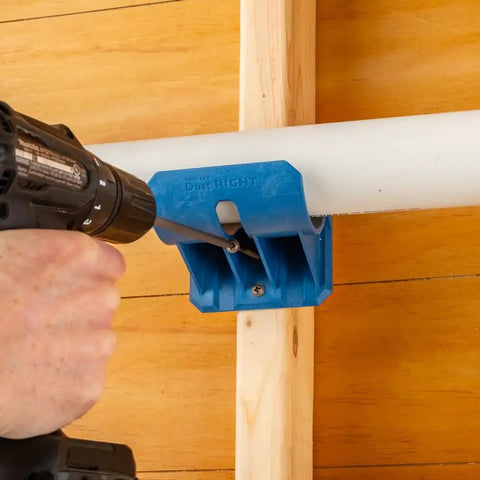 Premium Rockler Dust Right 4 Inch Hose Cradles shown in use with a drill to secure ABS clamp on PVC pipe.