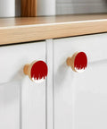 Top Tier Beech Wood Cabinet Knobs Round Drawer Pulls One Point Four Inch Abstract Graffiti Vibe Red And White Painted Furniture Hardware on white cabinets.