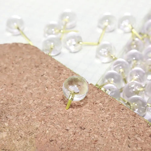 Clear push pin from Gold Paper Clips And Binder Clips Set 154 Pcs Must Have Office Supplies Bundle on a cork board