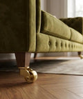 Heavy Duty Brass Casters Four Pack Double Ball Bearing Furniture Wheels Rust Resistant on sofa leg in living room.