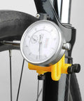 Beast Pro Grade Bike Wheel Truing Stand With Precision Percentage Table on a bicycle, focusing on rim alignment tool in use.