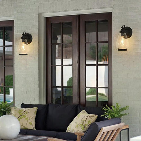 Sharp Badass Hella Waterproof Outdoor Wall Lantern With Slick Clear Glass Shade And Tough Diecast Aluminum Build For Front Porch Or Backyard Vibes Fits E27 Right Now Tonight on a white wall beside double glass doors.