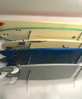 Dude Approved Surfboard Wall Mount Rack With Padded Arms Holds Four Shred Ready Boards Adjustable Height Wall Storage Organizer Keeps Shortboards And Longboards Secure Off The Floor with surfboards mounted.