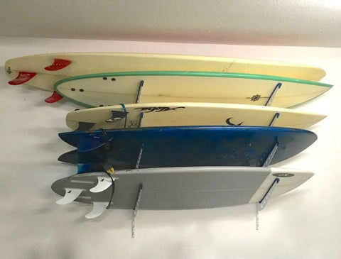 Dude Approved Surfboard Wall Mount Rack With Padded Arms Holds Four Shred Ready Boards Adjustable Height Wall Storage Organizer Keeps Shortboards And Longboards Secure Off The Floor with surfboards mounted.