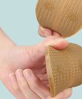 Polyurethane Shoe Heel Repair Pads Half Round Sole Protectors For Sneakers And Athletic Kicks held in hand, textured surface.