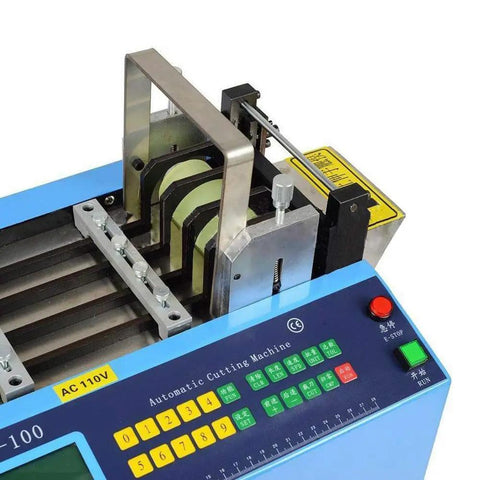 Close-up of Automatic Heat Shrink Tube And Cable Cutting Machine With Programmable Digital Controls cutting various materials.