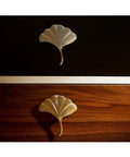 Slick Brass Cabinet Handle With Fresh Modern Nordic Vibe Sturdy Electroplated Furniture Knobs For Drawers Doors on dark and light wood.