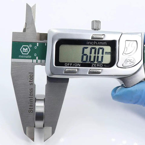 Digital caliper measuring 6.00mm diameter of a 6900RS Deep Groove Ball Bearing 10 Pack Double Rubber Sealed 10X22X6MM.