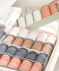 Six Piece Pink Plastic Underwear Drawer Organizer Set Smooth Dresser Storage Dividers with neatly arranged socks in drawer.